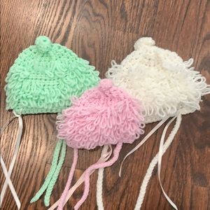 Three handmade baby hats
